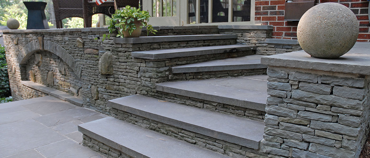 stone patio and stairs leading to back yard
